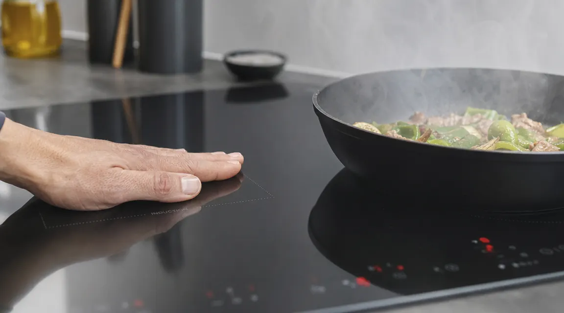 Induction cooktop surface staying cool while pan heats on top